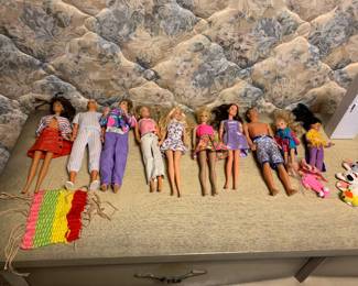 Assorted Barbie dolls and Ken dolls