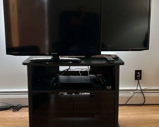 Two Samsung Flat Screen TVs And TV Stand