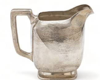 Frank Smith Silver Co. (American) Modern Sterling Silver Pitcher, Ca. 1930, H 8.25" W 4.75" L 9" 25.59t oz | Offers a modernist style with curved forms. Bearing signature branding and hallmarks to the underside. Total weight: 25.59 troy ounces. Circa 1930. Provenance: Property of a Grosse Pointe Park, MI private collector.