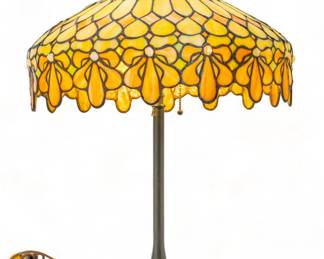Duffner & Kimberly (American (Est. 1905)) Art Glass Table Lamp Ca. 1910-1920, H 22" Dia. 18" | Geometric and drop panels in green with butterscotch swirls. Drop lily border with white jewel chunk stamens. on a bronze base by the Unique Lamp Company. Provenance: Property from the Estate of David Walicki, East Tawas, MI