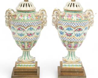 Saxon Porcelain Manufactory (Dresden) Painted Urns, Converted to Lamps, Ca. 1900, H 33" W 6" L 9" 1 Pair | the painted porcelain potpourri urns offer repetitious floral forms accented with fired gold trim, horned ram heads on the shoulders. Shades not included. Electrified lamps. Circa 1900. Provenance: Property from a private collection, West Bloomfield Township, Michigan.