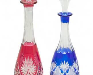 Bohemian Cut-to-Clear Crystal Decanters, Ca. 1950, H 16" Dia. 3.75" 2 pcs | the lot includes a ruby cut-to-clear decanter with matching stopper (H 16" X DIA 3.75") and a cobalt cut-to-clear crystal decanter with a glass stopper (H 15.25" X DIA 4"). No maker's marks or branding seen. Circa 1950. Provenance: Property from a private collection, West Bloomfield Township, Michigan.