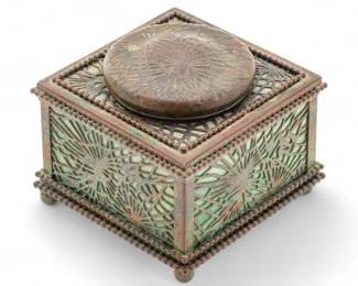 Tiffany Studios (American, 1878-1938) Bronze Pine Needle And Favrile Glass Inkwell, #844, Ca. 1910, H 3.5" W 4" | Signed "Tiffany Studios New York #844". Hinged cover. Beaded borders. on ball feet. Mottled green and milky white glass. Original glass ink insert. Provenance: Property of a Prominent Grosse Pointe, MI Collector