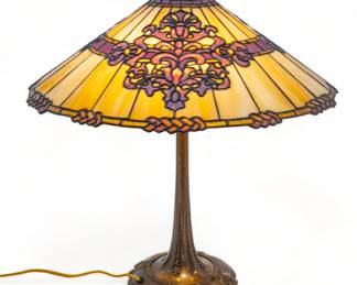 Duffner & Kimberly Co. (American (Est. 1905)) Leaded Glass Table Lamp Ca. 1910, "Russian", H 23" Dia. 22" | Butterscotch glass ground encases three Russian style cartouches in voilet/purple glass. Original base. Provenance: Property from the Estate of David Walicki, East Tawas, MI