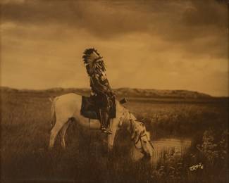 Edward S. Curtis (American, 1868-1952) Orotone Ca. 1905, "Oasis in the Badlands, Chief Red Hawk, Sioux", H 14" W 17" | Printed: Circa 1920-29.  Signed and 'LA' Copyright in the image lower right, in the original Curtis Studio batwing frame, with the Los Angeles studio label attached to the reverse.  Literature: Edward S. Curtis: the North American Indian, the Complete Portfolios, Taschen, 1997, Vol. III, p. 142; Cardozo, Edward Curtis: One Hundred Masterworks, Delmonico Books/ Prestel, 2015, p. 143.  Frame Measurements: H. 19"  W. 21.5".