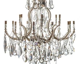 Austrian Crystal 18-Light Chandelier, H 34" Dia. 34" | the chandelier boasts hanging crystal prism forms including tear drop, spheres with garlands of diamond cut prisms. Offers six candlestick arms to the top tier and twelve candlestick arms to the lower tier. Electrified. Provenance: Property of a Birmingham, MI private collector. 