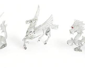 Swarovski (Austrian) 'Fabulous Creatures' Crystal Figurines, 'The Dragon', 'The Pegasus' & 'The Unicorn', H 3.75" W 2" L 5.5" 3 pcs | the collection includes 'The Dragon' figurine (H 3.75" X W 2" X L 5.5") with presentation stand, one 'The Pegasus' figurine (H 5" X W 1.25" X L 6") with presentation stand, and one 'The Unicorn' figurine (H 4.25" X W 1.25" X L 6") with presentation stand. Each accompanied with original box, measuring H 5" X W 9.5" X D 9.75" respectively. Provenance: Property from a Brighton, MI private collection. 