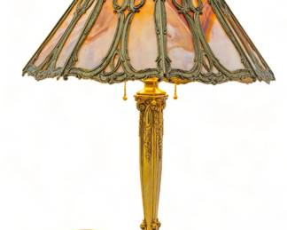 Bradley & Hubbard Manufacturing Company (American (1852-1940)) Slag Glass in Gold Patina Frame Table Lamp H 26" Dia. 16" | Eight Butterscotch slag glass panels set in gold patinated shade frame. on a matching gold patinated Louis XIV style base. Base and shade impressed with the company mark. Bryant (1907) sockets. Provenance: Property from the Estate of David Walicki, East Tawas, MI