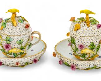 Meissen (German) Schneeballen Porcelain Cups, Covers & Saucers, Ca. 1880, H 5.5" Dia. 5.5" 1 Pair | the covered teacups and saucers are adorned in white snowball flowers, blooming roses and vine tendrils, and perched canaries with yellow plumage. Each bearing signature crossed swords mark to the undersides under glaze. Circa 1880. Provenance: Property from a private collection, Grosse Pointe Farms, Michigan.