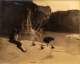 Edward S. Curtis (American, 1868-1952) Orotone Ca. 1904, "At the Old Well of Acoma", H 11" W 14" | Printing: Circa 1920-29.  Signed in the image lower right, in the original Curtis Studio batwing frame, with the Curtis Studio 4th at University, Seattle paper label affixed to the reverse.  Literature: Edward S. Curtis: the North American Indian, the Complete Portfolios, Taschen, 1997, Vol. XVI, p. 621; Cardozo, Edward Curtis: One Hundred Masterworks, Delmonico Books/ Prestel, 2015, p. 148.  Frame Measurements: H. 15.75" W. 18.75".