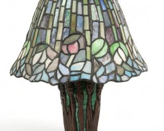 Tiffany Style Leaded Art Glass Table Lamp, 20th C., H 14" Dia. 9" | Bell-shaped art glass shade with floral designs. Patinated metal base in the form of wheat stalks with green mosaic glass. Provenance: Property from the Estate of David Walicki, East Tawas, MI