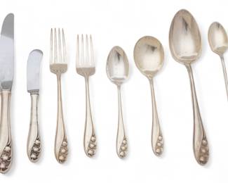 Gorham (American) & Whiting Mnfg. Co. (American) 'Lily of the Valley' Sterling Silver Flatware, 78.9t oz 81 pcs | the Gorham 'Lily of the Valley' collection includes 8 place knives (L 8.75"), 9 place forks (L 7"), 7 salad forks (L 6"), 16 teaspoons, 12 iced tea spoons, 8 cream soup spoons, 4 serving spoons (L 8.25"), 1 meat serving fork, 1 jelly spreader, 1 sugar tongs, 1 lemon fork, 1 master butter knife, 1 pierced spoon server, 2 ladles, 8 butter knives (L 6.25"), 2 pie/cake servers. the Whiting Manufacturing Co. 'Lily of the Valley' includes 3 teaspoons (L 6") and 1 master butter knife. Total weight: 78.9 troy ounces (weighable). Provenance: From a Prominent Print Collector, Clarkston, Michigan