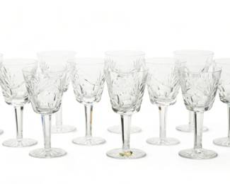 Waterford (Irish) 'Ashling' Cut Crystal Wine Glasses, H 6" Dia. 3" 12 pcs | the glasses offer repetitious fan cuts with fluted bowls on a faceted stem. Each bearing signature branding acid etched to the undersides. Provenance: Property from a Grosse Pointe Farms, Michigan private collector.
