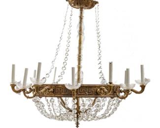 Attributed to Mel Rykus, Bronze & Crystal 12-light Chandelier, Ca. 1970, H 40" Dia. 40" | the chandelier offers a gilt bronze circular framework with a Greek key motif. Illuminates with twelve candlestick style lights, cut crystal beads strings and glass bobeches. Circa 1970. Provenance: Property from a Birmingham, MI private collector. 