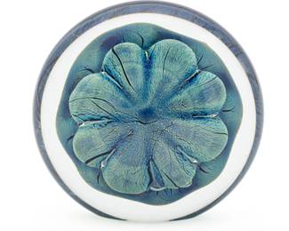 Robert G. Eikholt (American) Blown Art Glass Sculpture, 2002, H 4.24" W 5" Depth 2" 1 pc | the sculpture offers a rounded form with a central flower motif. the flower motif boasts an iridescent teal and cobalt tone. Signed and dated to the underside. Provenance: From the Estate of Prominent Collector, Leon Zielinski, Macomb County, MI