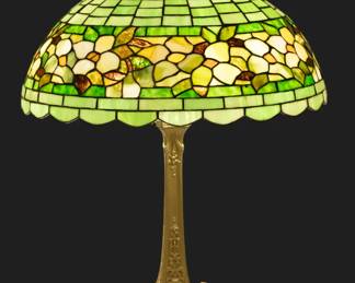 Wilkinson Art Glass Table Lamp Ca. 1910-1920, "Dogwood Border", H 26" Dia. 20" | White dogwood border on green. on gold patinated white metal base in the Louis XIV  style marked on underside 1106. Provenance: Property from the Estate of David Walicki, East Tawas, MI