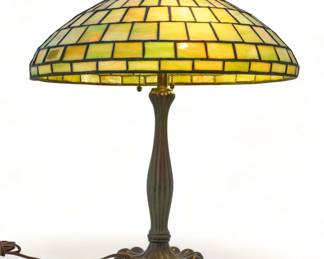 Duffner & Kimberly Leaded Art Glass Table Lamp, H 23" Dia. 19" | Green geometric leaded glass panes. Atop a patinated metal base with reeded column and bump design. Hubbell sockets. Provenance: Property from the Estate of David Walicki, East Tawas, MI
