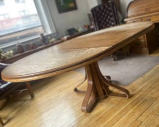 Solid Oak Dining Table Bent Wood Base. Round without leaf $600. Oval with 2 leaves. Seats up to eight people. Unusual artisanal cabinetry.