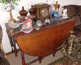Working/chimes mantle clock with key
Mahogany drop leaf table
Art glass paperweights
