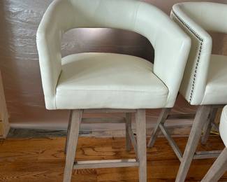 Off white faux leather swivel stools. Seats are 29”H