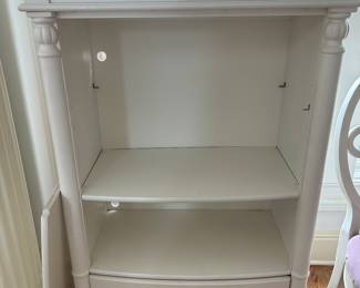 White bookshelf or media cabinet. It has two shelves and a drawer 54”H x 33”W