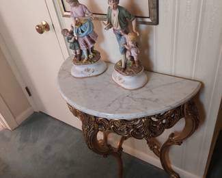 marble top half-moon table; ceramic figurines