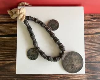 Omani silver pendant on a necklace with large silver beads and two 18th century coins on a thick cord