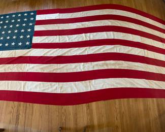Huge early 48 star American flag, 8’ x 15’, all stitched with appliqué stars, some minor water stains, c 1912-1917, around 1918 federal law stated that all US flags are to be in straight rows and columns and this flag is staggered, linen