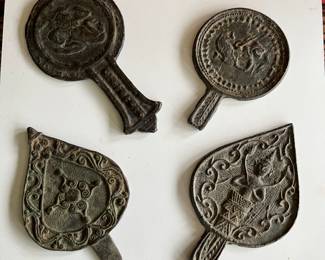 A collection of antique bronze Popil, sacred Khmer ceremonial objects, originating in Cambodia, used during celebrations like weddings or the consecration of a temple