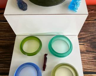 A collection of very early Southeast Asian carved glass bracelets and amulets