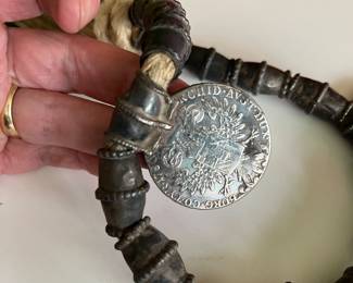 Omani silver pendant on a necklace with large silver beads and two 18th century coins on a thick cord