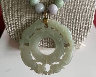 Multi-colored jade beaded necklace with a large antique jade pendant