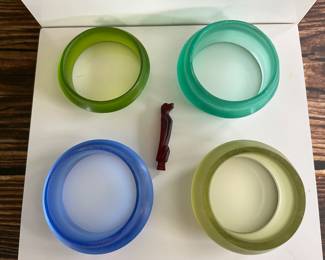 A collection of very early Southeast Asian carved glass bracelets and amulets