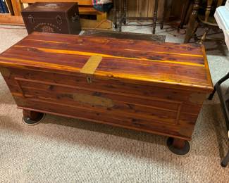 True Cedar chest with brass/copper clasp and rolled feet.  Tray slides from side to side.  Excellent condition.