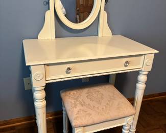Vanity with swing mirror and stool.