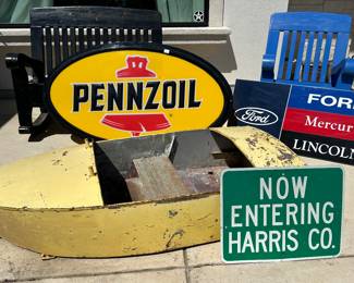 Amusement park metal boat , Pennzoil , car dealer, and road signs