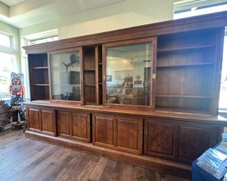 Absolutely stunning 1800’s Antique Drugstore Display / Sideboard has 4 Sliding Glass Doors above and wood sliding cabinet doors beneath.  The top and bottom  shelving come apart for transport.  The top, counter and bottom are full pieces. 