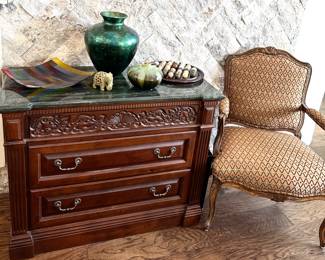One of two solid wood nightstands with marble tops. There are also two of these beautifully upholstered chairs. 