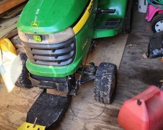 2011 John Deere X300 Lawn Mower. 18HP, Hydrostatic, 48" Mower Deck. Mower comes packaged with a 44" snow blade, chute & bagger, and wagon.