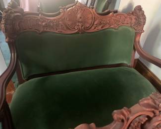 Green parlor sofa with carved mahogany trim