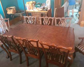 Claw foot dining table with extra leaf, table pad and 8 chairs