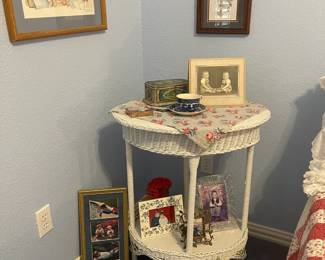 Oval wicker two tiered table with wooden top.