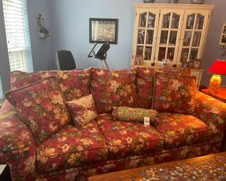 Pretty red floral sofa and French Country bookcase