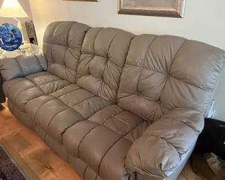 $ 350 each one of two matching faux leather Taupe reclining sofas reclining push buttons on both ends ( one has loose button and slight tear on side ) 85W x 34D x 40H