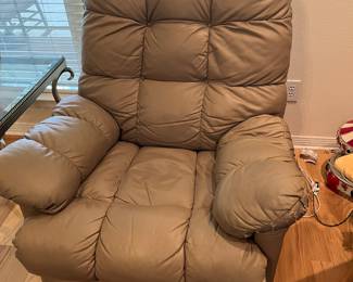 $ 120 one of two Taupe faux leather manuel recliner and rocker 34W x 35D x 42H 2nd chair has damage on left arm rest and is $80