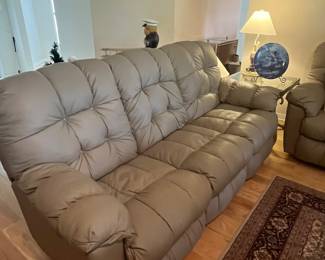 $ 350 each one of two matching faux leather Taupe reclining sofas reclining push buttons on both ends ( one has loose button) 85W x 34D x 40H