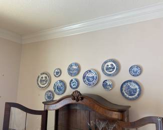 #88 - $68 - Set of 11 English B&W plates hanging above china cabinet