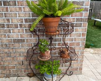#56 - $100 - Wrought Iron 3 Tier Plant Stand  29"Wx62"H with plants on it