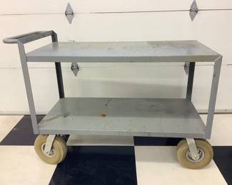 NIAB802 Rolling Utility Cart Rolling utility cart. Measures approximately 48" long by 24" wide by 34" tall. Has a stopper intended to clamp onto a block of wood.
