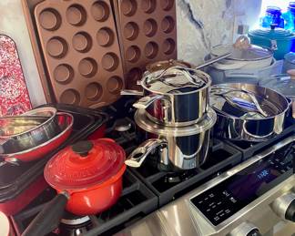 Le Creuset and Royal Doulton by Gordon Ramsay pots and pans as well as red enamel ware and copper ware. 
